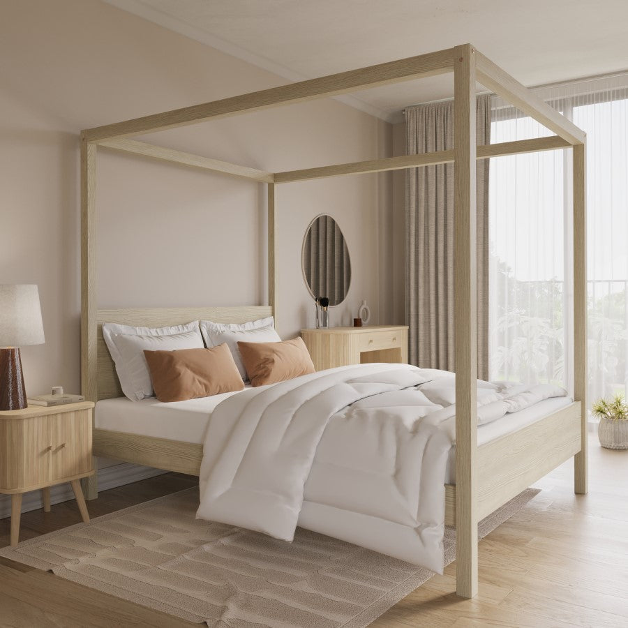 Wooden oak four poster bed in a modern bedroom with light decor