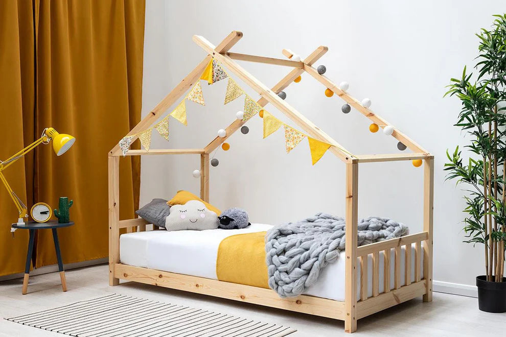 kids wooden canopy bed frame in a bedroom